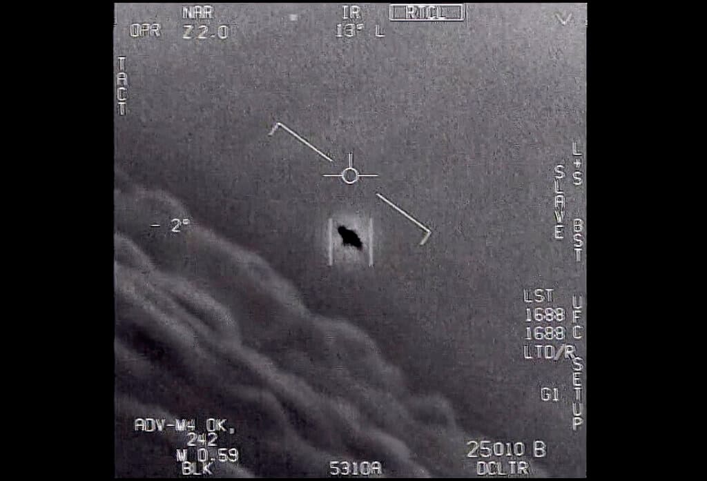 Department of Defense via AP in this image from video provided by the Department of Defense, from 2015, an unexplained object is seen at center as it is tracked as it soars high along the clouds, traveling against the wind.