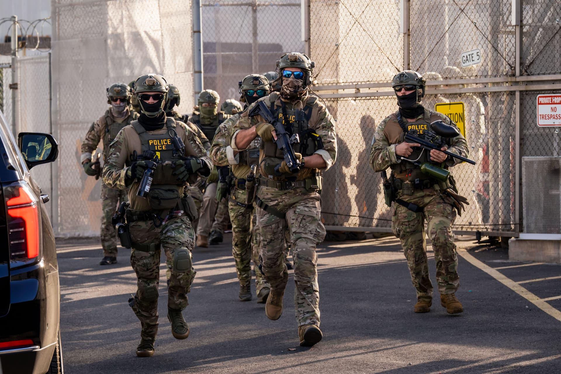 Adam Gray/Getty Images Immigration and Customs Enforcement (ICE) agents run out of Delaney Hall Immigration Detention Center as they protect vehicles during a shift change on June 7, 2026 in Newark, New Jersey.