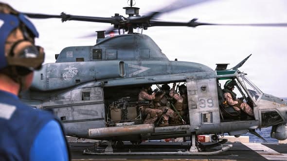 U.S. Central Command via Facebook In this photo released June 9, 2026, U.S. Marines with the 31st Marine Expeditionary Unit load onto a UH-1Y Venom aboard USS Tripoli (LHA 7) to conduct aerial sniper and close air support training while transiting regional waters.