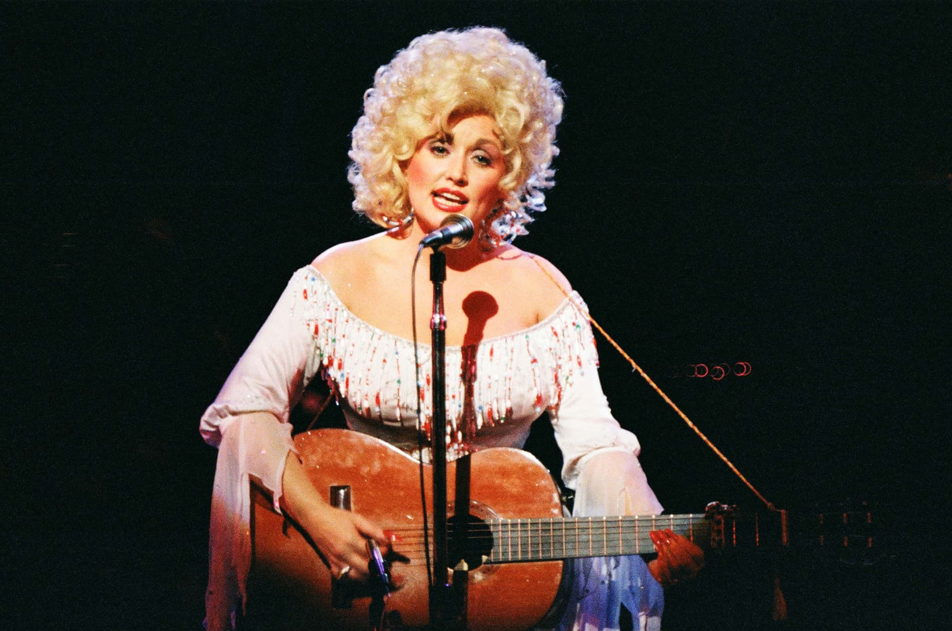 Pete Still/Redferns via Getty Images Dolly Parton performs on stage at London's Dominion Theatre on March 29, 1983.