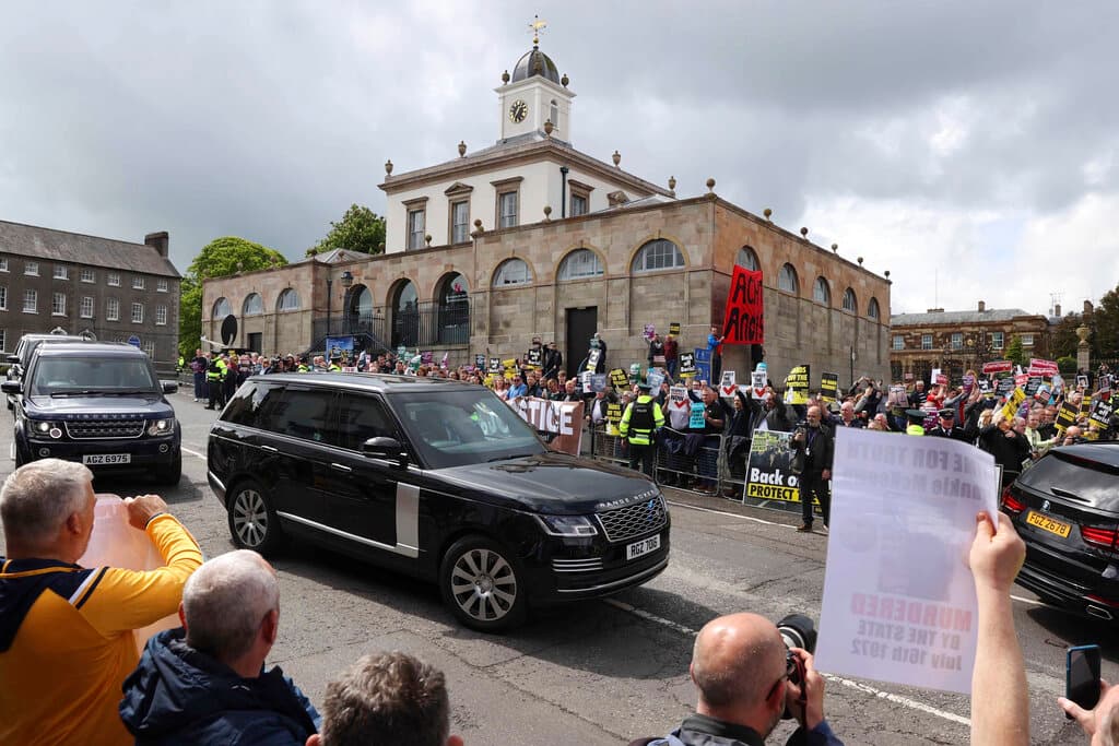 People demonstrate outside Hillsborough Castle as the motorcade of the British prime minister passes by at Hillsborough, Northern Ireland, May 16, 2022. Liam McBurney/PA Wire/PA via AP