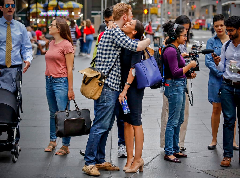 Alexandria Ocasio-Cortez, center, and campaign volunteer Riley Roberts, Wednesday, June 27, 2018, in New York. AP Photo/Bebeto Matthews