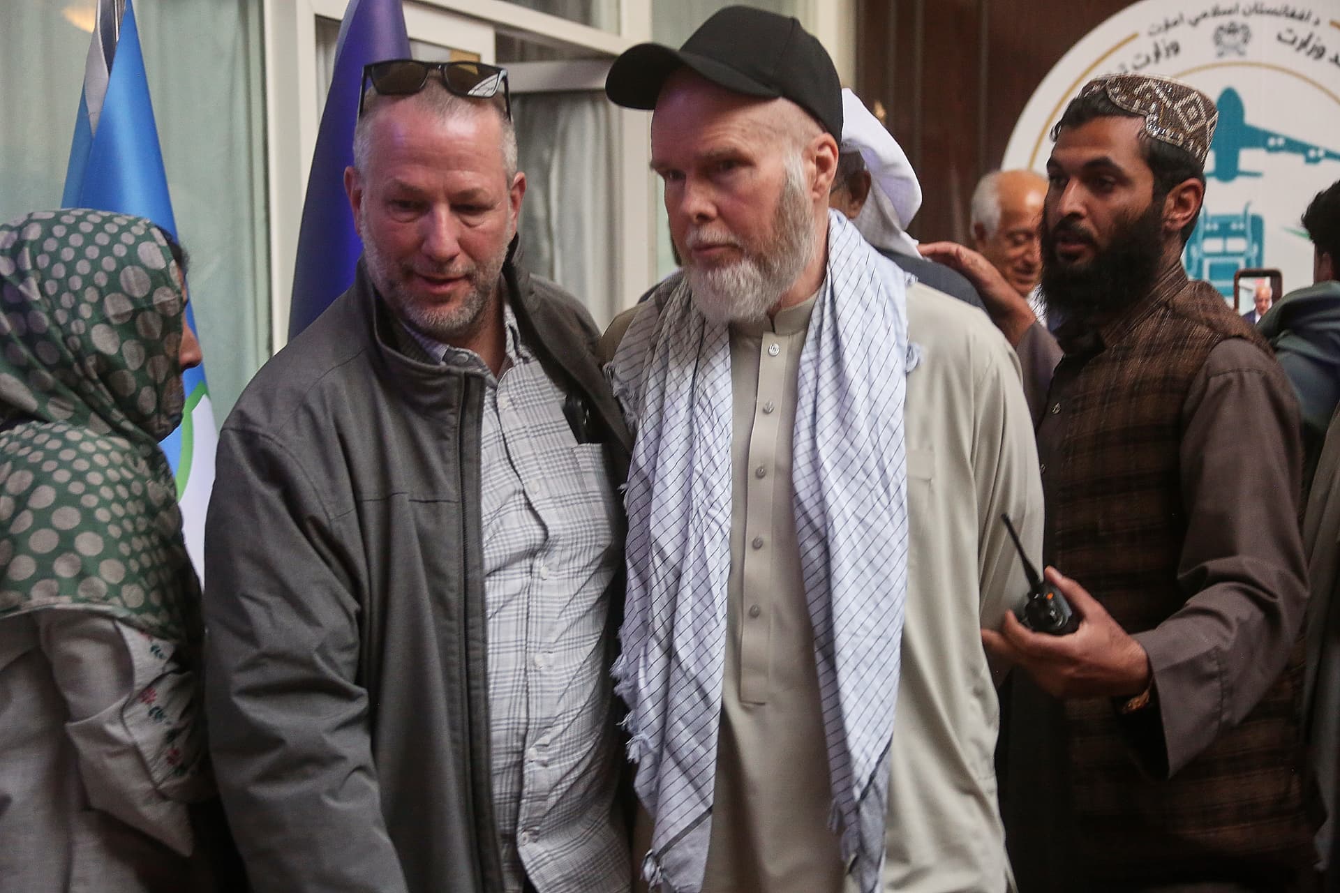 AP/Mudassir Safi American Dennis Coyle, second from right, is accompanied by an unidentified person after being released by Afghanistan's Taliban authorities.