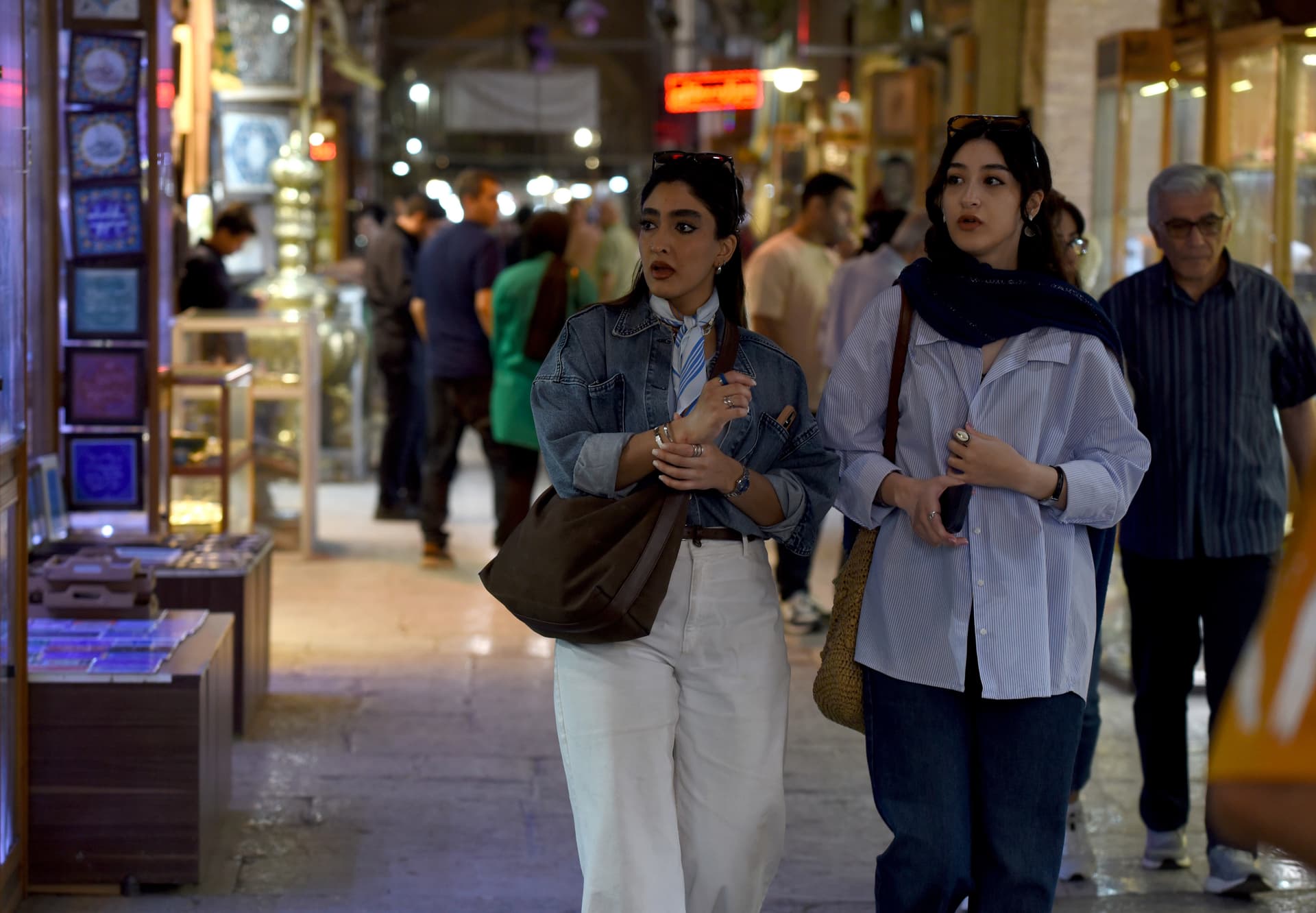 Kaveh Kazemi/Getty Images Young women walk without head coverings in the main bazaar at Isfahan, Iran, on April 30, 2026.