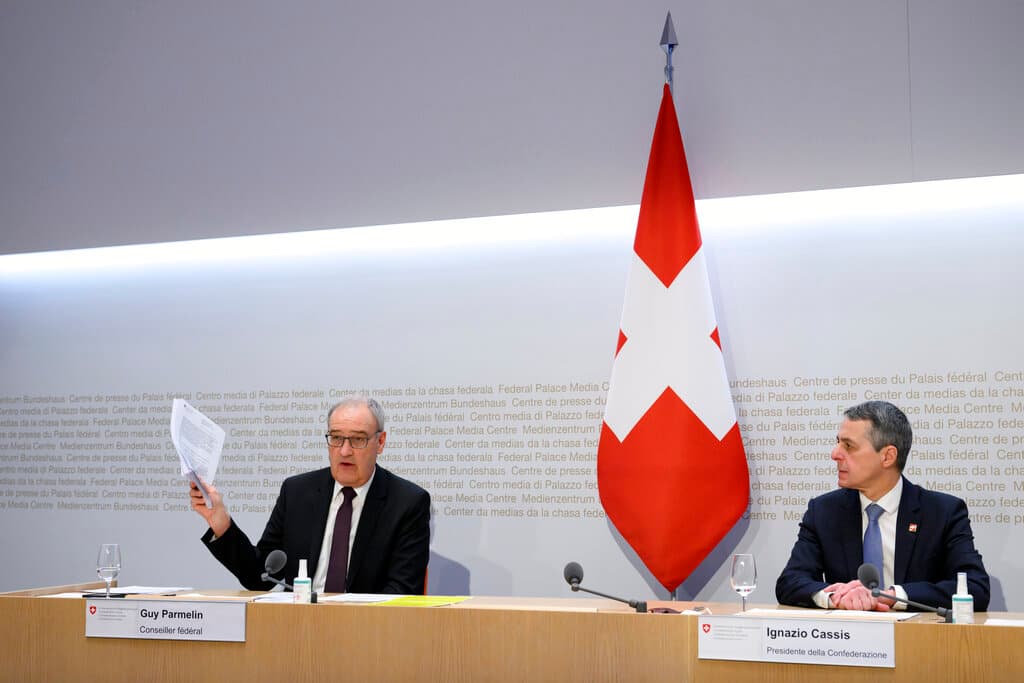 Federal Councillor Guy Parmelin, left, speaks alongside Federal President Ignazio Cassis during a conference at Bern in February. AP/Anthony Anex/Keystone