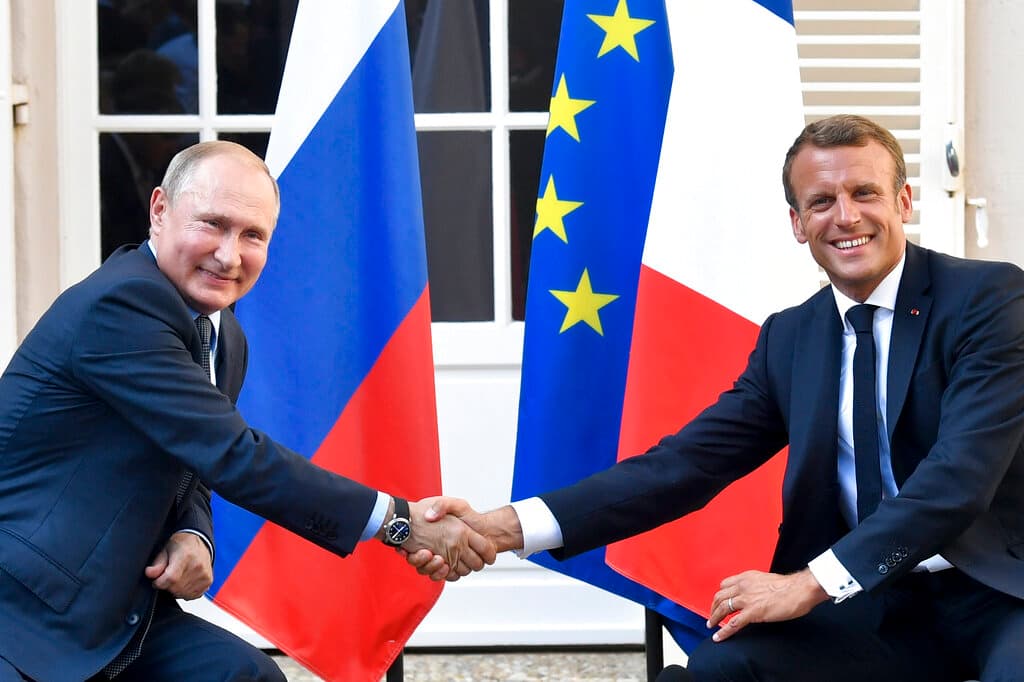 Gerard Julien, pool via AP, file Presidents Putin and Macron in 2019.
