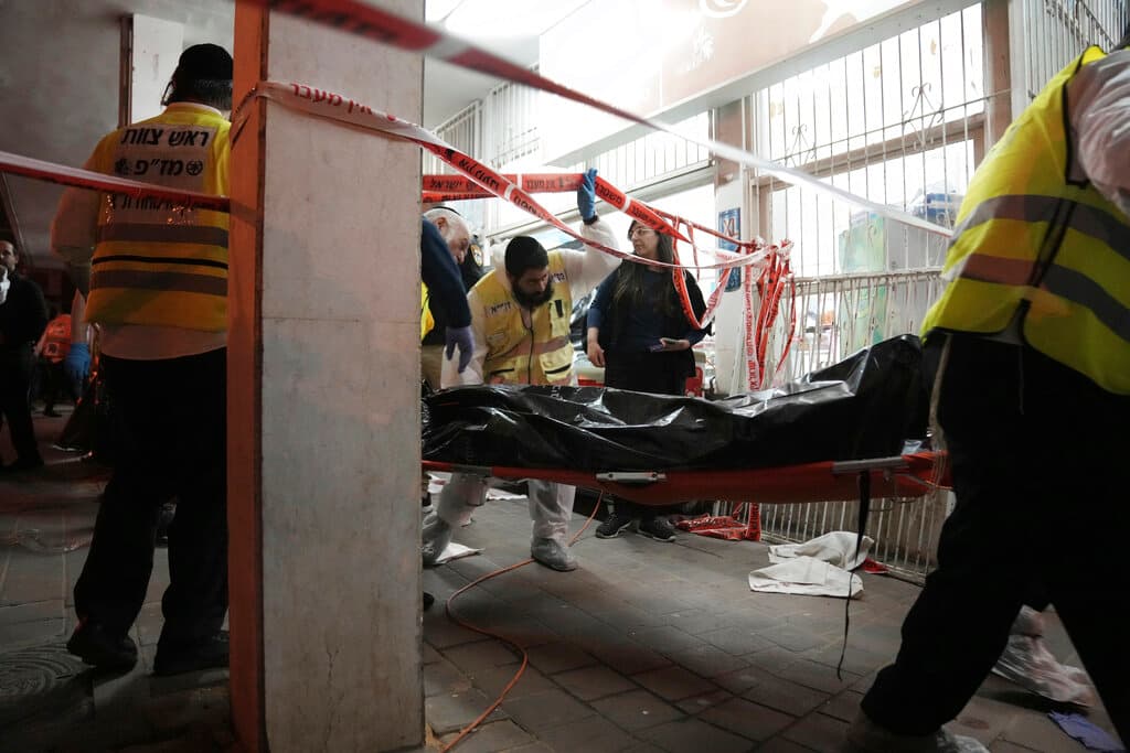 A body is removed from the site where a gunman opened fire in Bnei Brak, Israel, March 29, 2022. AP/Oded Balilty