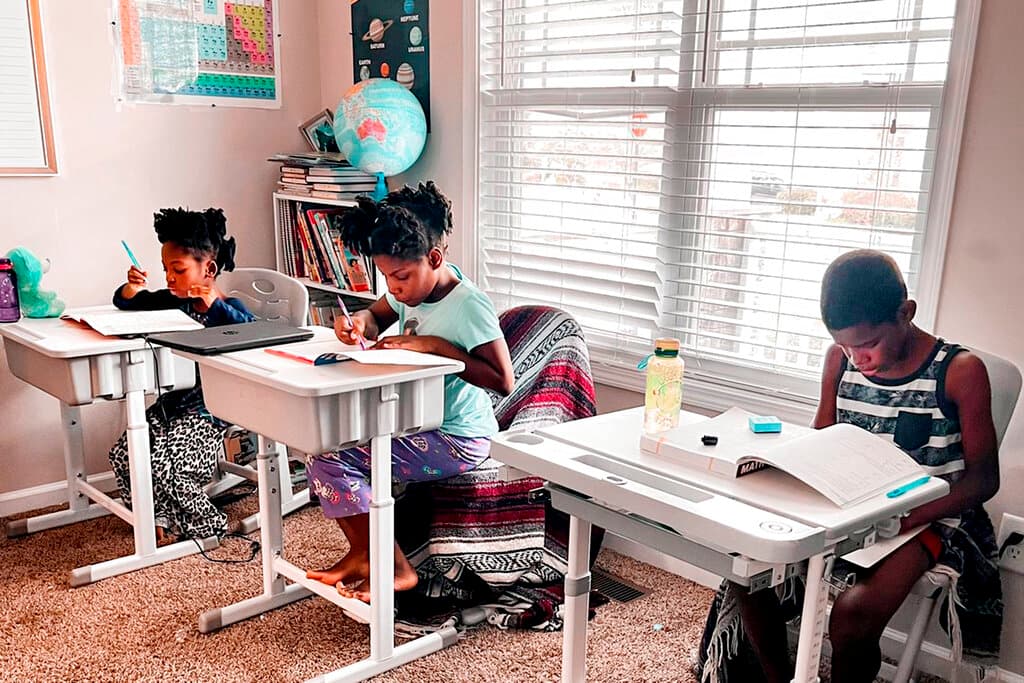 Courtesy of Dalaine Bradley via AP Drew Waller, 7, Zion Waller, 10, and Ahmad Waller, 11, left to right, study during homeschooling, at Raleigh, North Carolina.