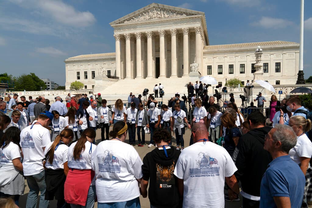 People pray outside of the U.S. Supreme Court May 3, 2022. AP/Jose Luis Magana