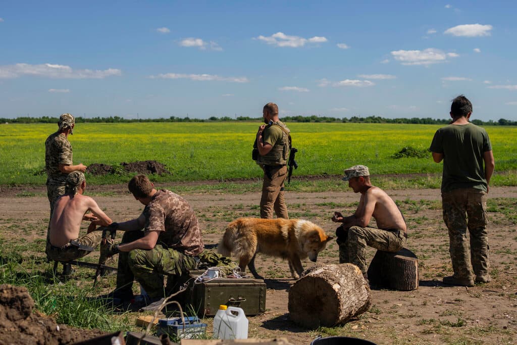 AP/Bernat Armangue Ukrainian servicemen take a break after digging trenches near the frontline in Donetsk region, eastern Ukraine, June 8, 2022.