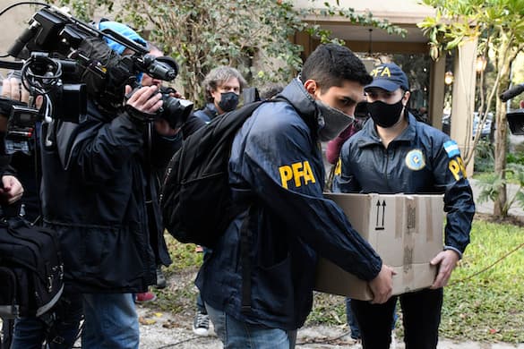 AP/Gustavo Garello Police officers confiscate a box of documents during a judicial raid at the Plaza Central Hotel, where the crew of a Venezuelan-owned Boeing 747 cargo plane are staying, at Buenos Aires June 14, 2022.