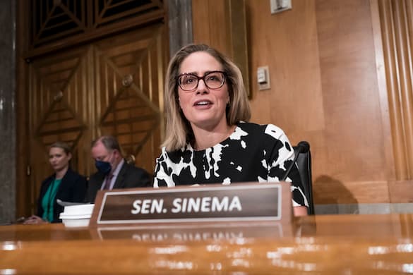 AP/J. Scott Applewhite Senator Sinema at the Capitol August 3, 2022. She is one of the three lawmakers negotiating the immigration reform plan.