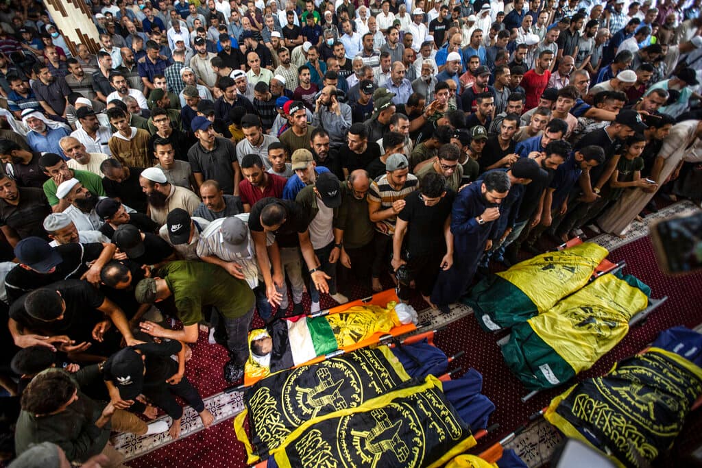 AP/Yousef Masoud Mourners pray next to the bodies of Khaled Mansour, a senior commander in the Palestinian militant group Islamic Jihad, and other Palestinians who were killed in Israeli airstrikes.