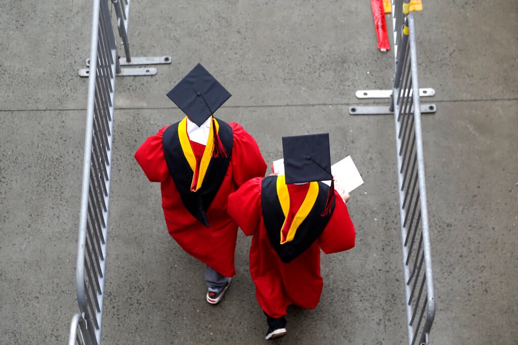 AP/Seth Wenig, file New graduates before the start of the Rutgers University graduation ceremony at Piscataway Township, New Jersey.
