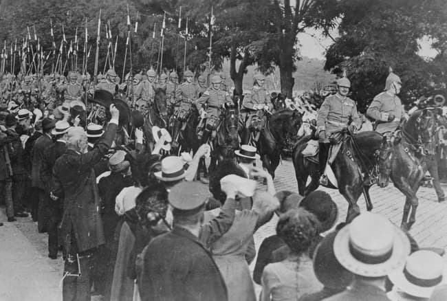 National Archives via Wikimedia Commons Berliners cheer as a German cavalry regiment leaves for the front in August, 1914.