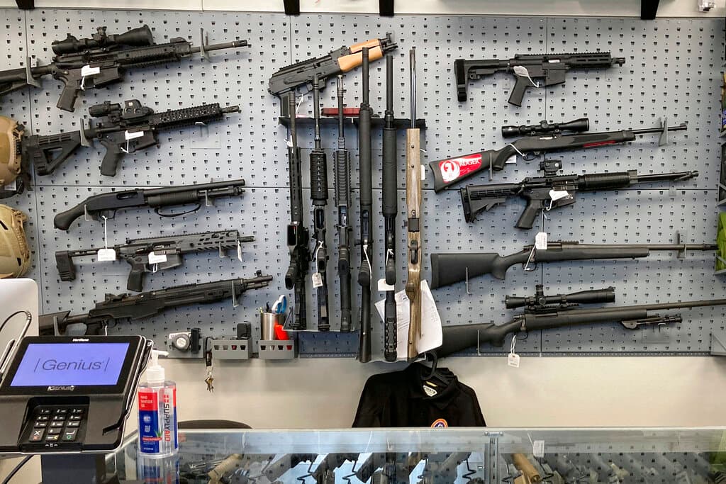 AP/Andrew Selsky Firearms on display at a gun shop.