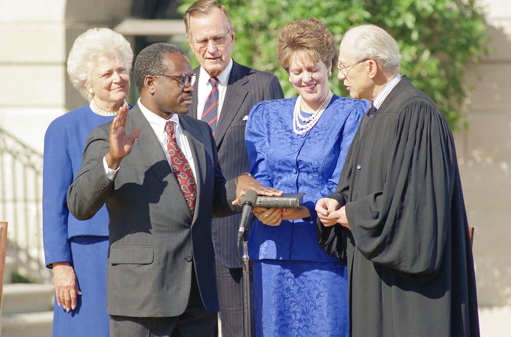 AP/Greg Gibson Clarence Thomas is sworn into office by Justice Byron White, right, while his wife, Virginia, holds the Bible on October 19, 1991.