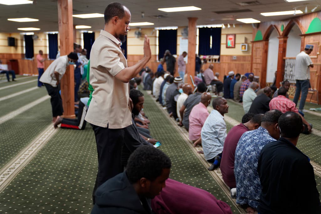 AP/Jessie Wardarski The director of the Islamic Association of North America, Yusuf Abdulle, standing, with other Muslims praying at the Abubakar As-Saddique Islamic Center at Minneapolis in 2022.