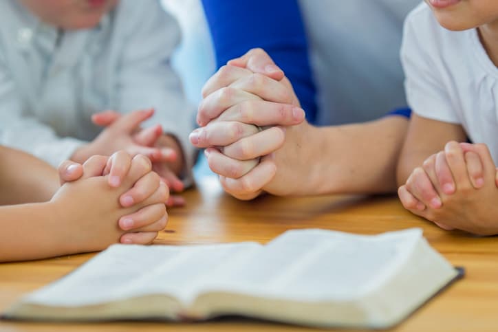 Getty images Children praying in school.