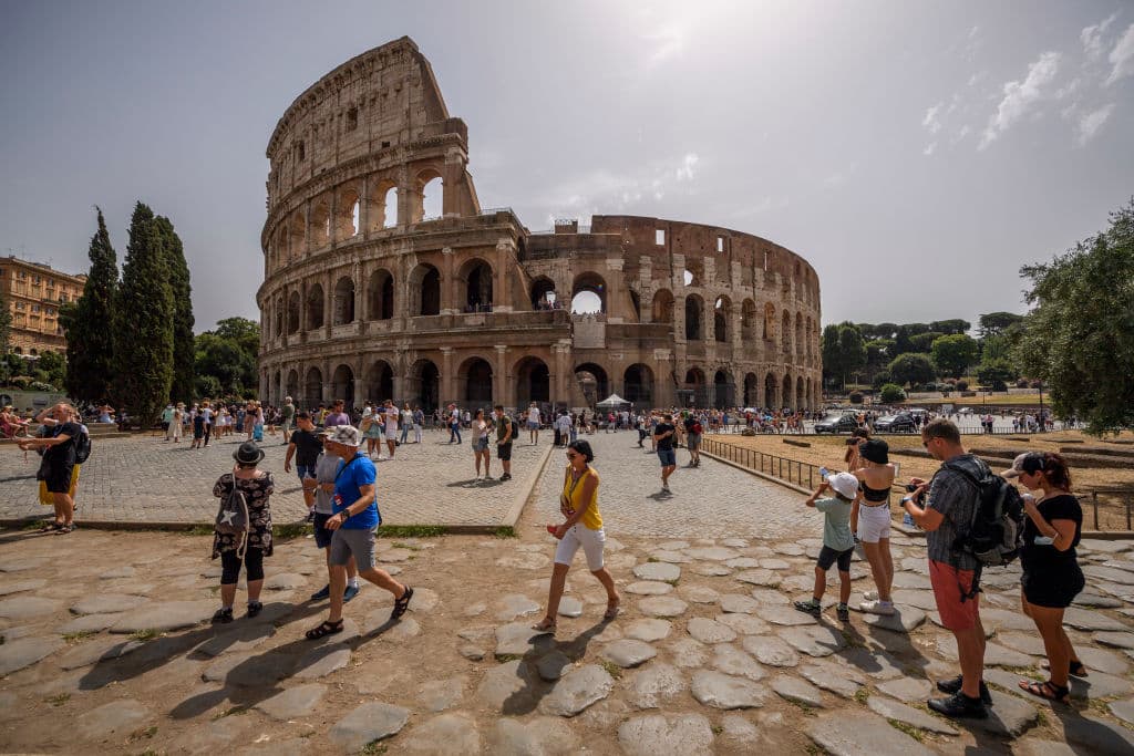 Antonio Masiello/Getty Images People refresh themselves outside the Colosseum amid high temperatures at Rome, on August 10, 2021.