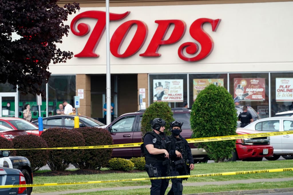 Derek Gee/the Buffalo News via AP, File Police secure the area around a supermarket where several people were killed at Buffalo, New York, May 14, 2022.