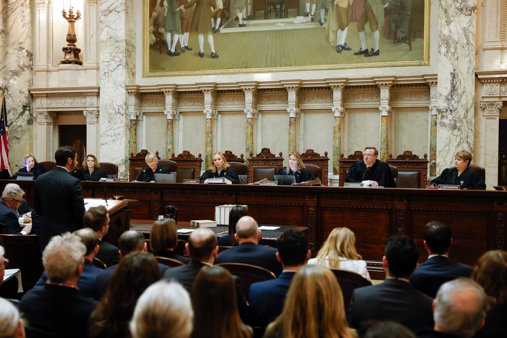 Ruthie Hauge/The Capital Times via AP The Wisconsin supreme court listens to arguments from a Wisconsin assistant attorney general, Anthony Russomanno, during a redistricting hearing at the state capitol.
