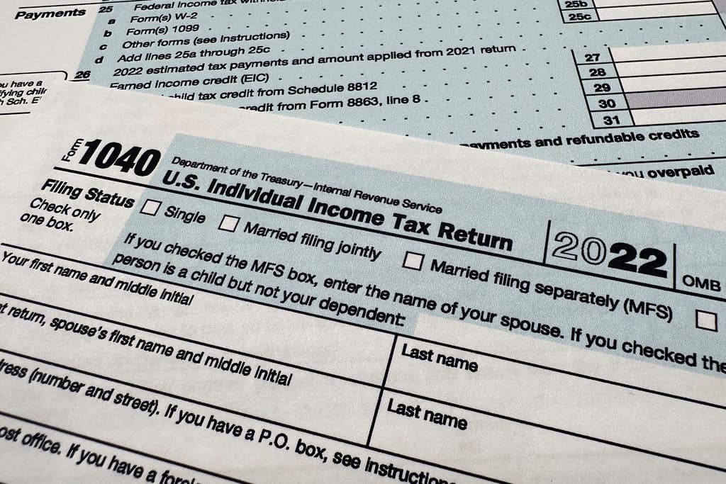AP/Jon Elswick, file The Internal Revenue Service 1040 tax form.