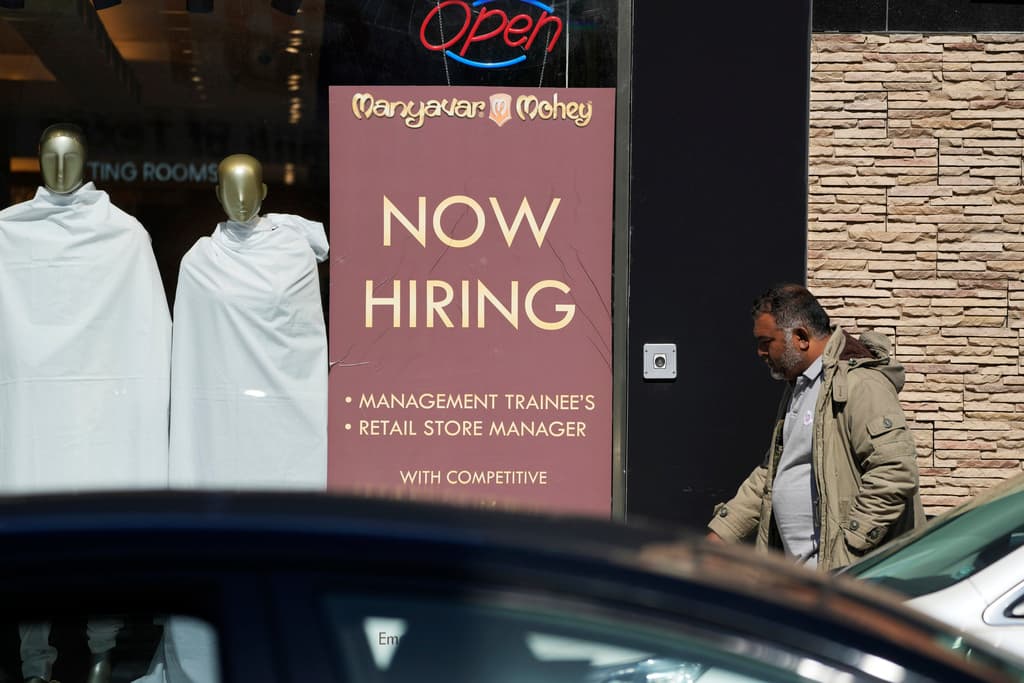 AP/Nam Y. Huh A hiring sign is displayed at a retail store at Chicago.