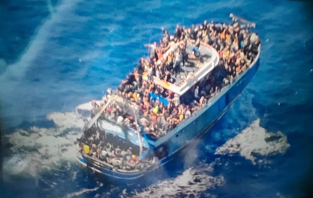 Hellenic Coast Guard via AP Scores of people sit on a battered fishing boat that later capsized and sank off southern Greece.