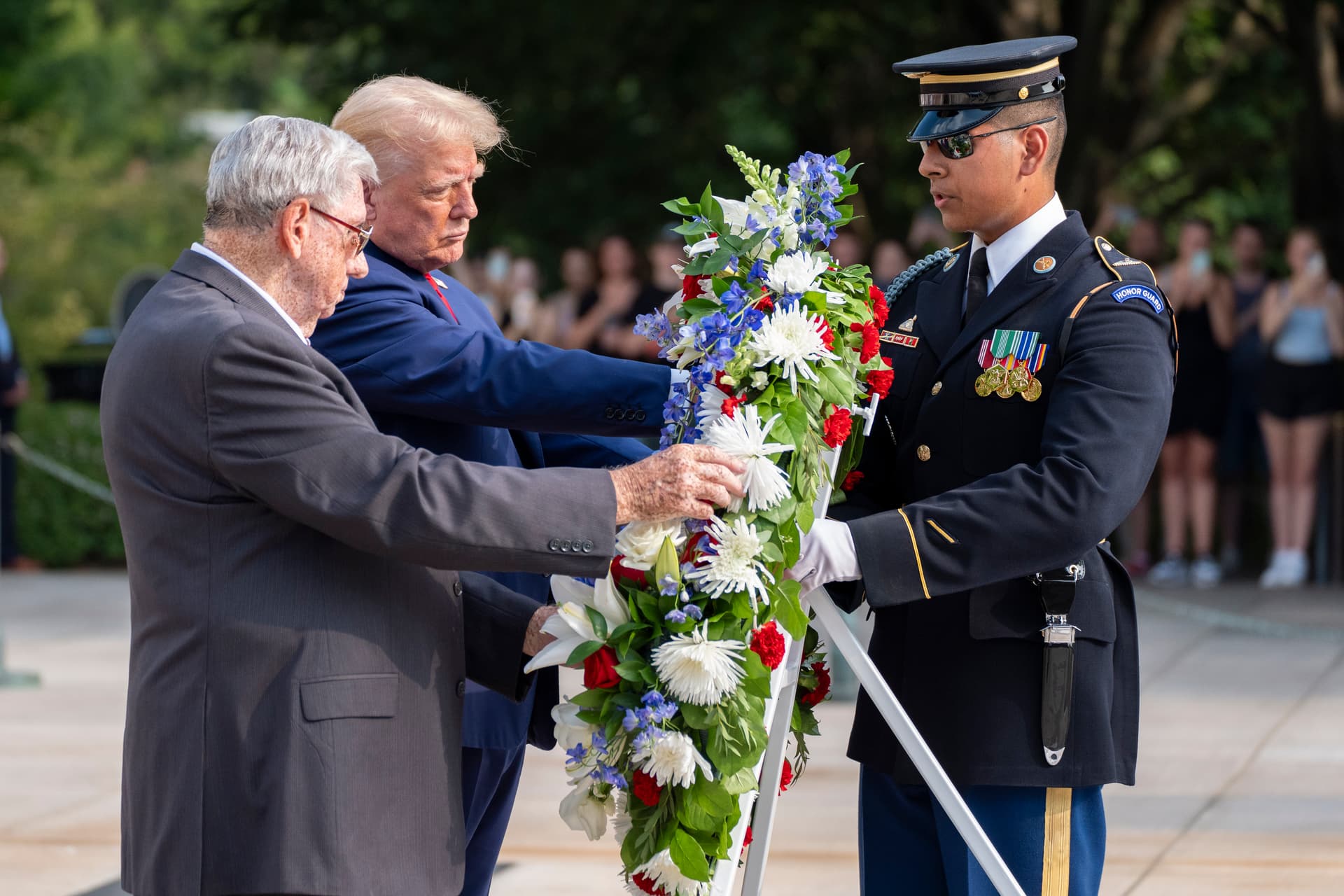 AP/Alex Brandon Bill Barnett, left, grandfather of Darin Taylor Hoover, and President Trump place a wreath at the Tomb of the Unknown Solider at Arlington National Cemetery.