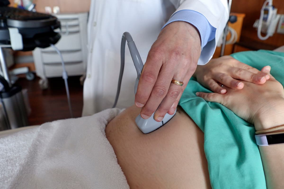 AP/Teresa Crawford A doctor performs an ultrasound scan on a pregnant woman.