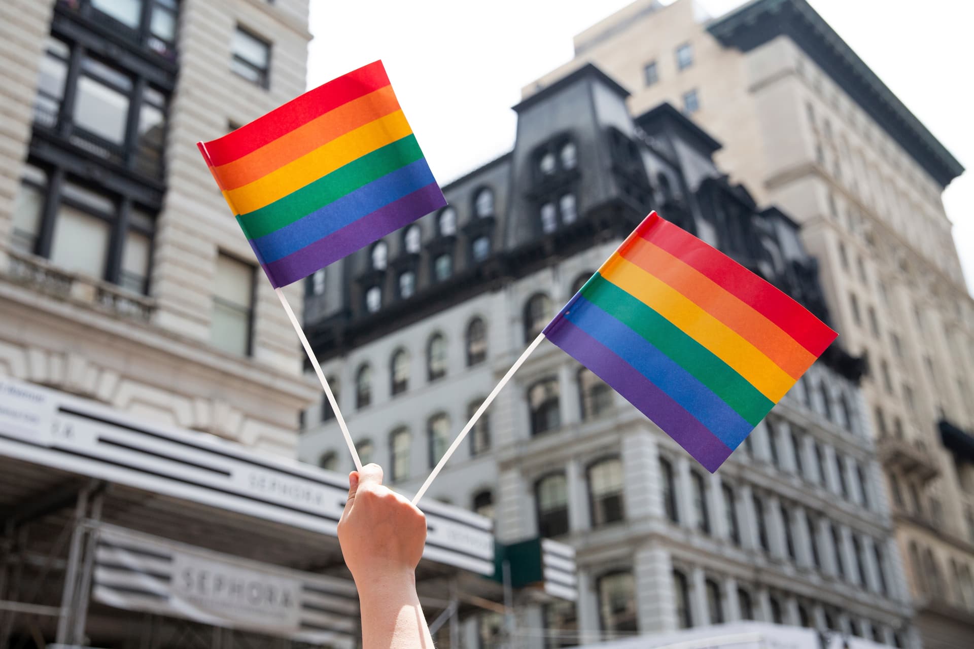 AP/Steve Luciano A person holds up LGTBQ+ pride flags during the Pride Parade at New York.