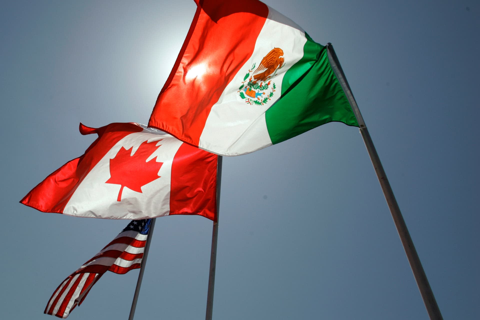 AP/Judi Bottoni Flags representing the United States, Canada, and Mexico.