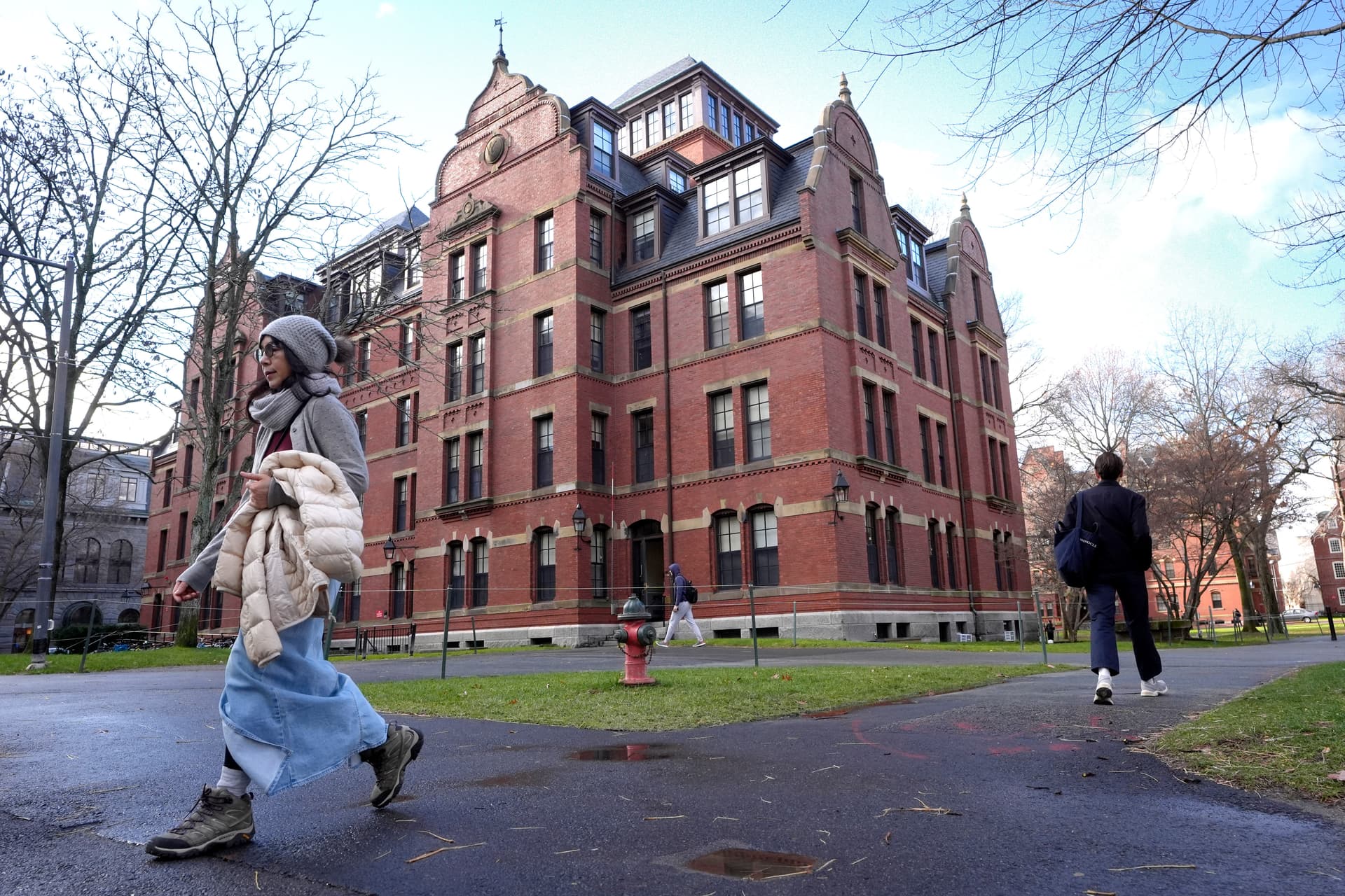 AP/Steven Senne People walk between buildings on the campus of Harvard University.
