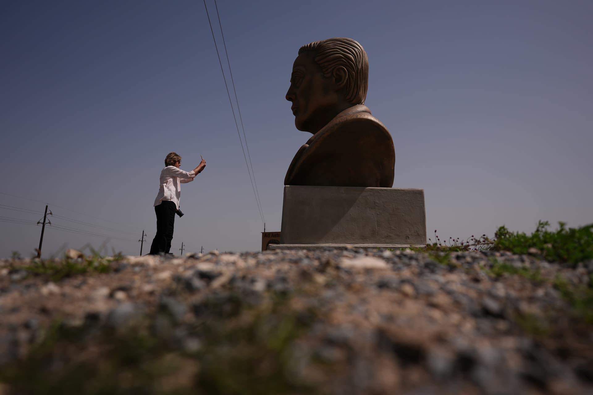 AP/Eric Gay A visitor photographs a large bust of Elon Musk near SpaceX's Starbase in Boca Chica, Texas, March 5, 2025.