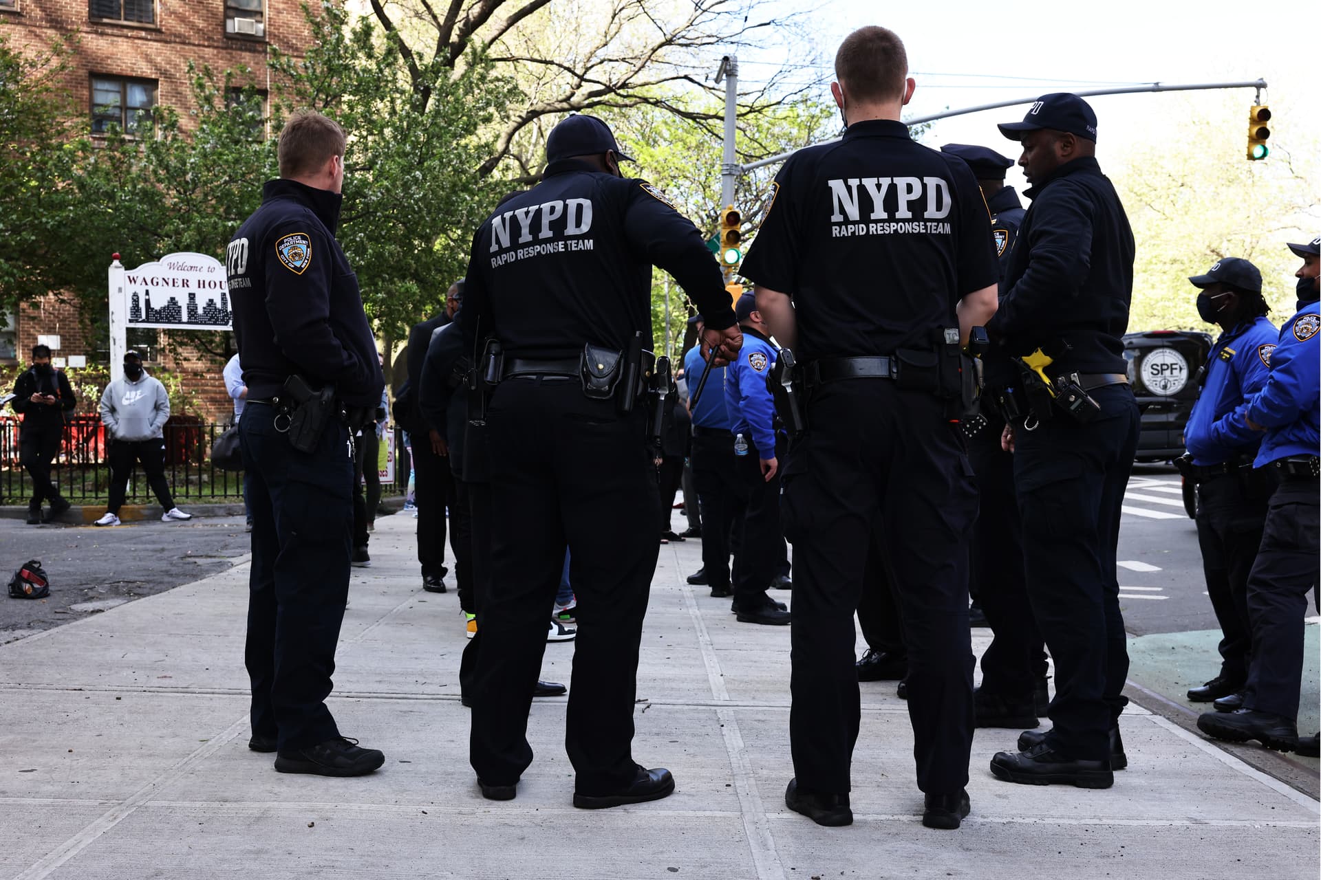 Michael M. Santiago/Getty Images NYPD officers await the start of a peace walk to denounce gun violence in the city.