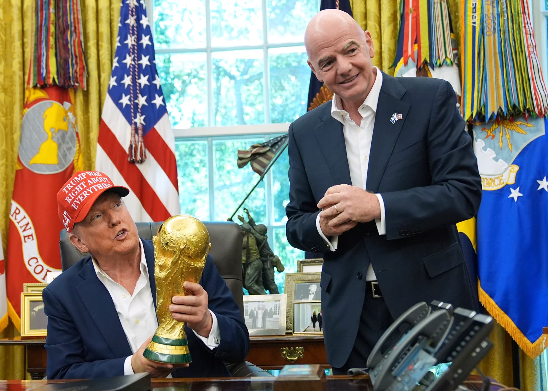Jacquelyn Martin/AP President Trump holds the FIFA World Cup Winners Trophy as the FIFA president, Gianni Infantino, looks on at the White House on August 22, 2025.