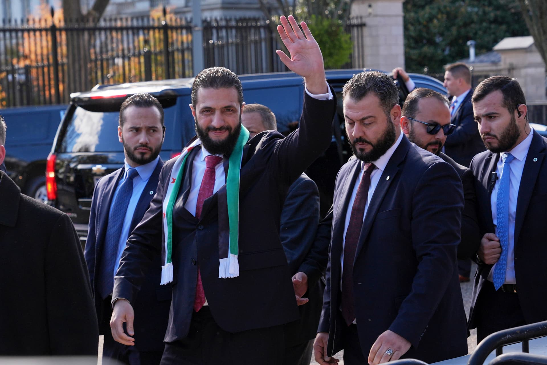 AP/Jacquelyn Martin President Ahmed al-Sharaa of Syria waves as he greets supporters outside of the White House, November 10, 2025, at Washington.