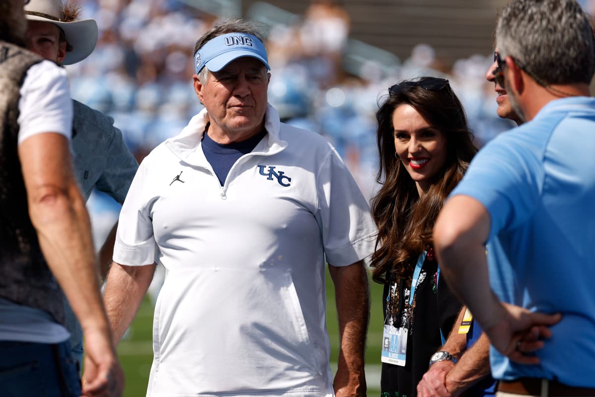 Lance King/Getty Images Head coach Bill Belichick of the North Carolina Tar Heels and girlfriend Jordon Hudson look on prior to a game at Chapel Hill, North Carolina on September 13, 2025.