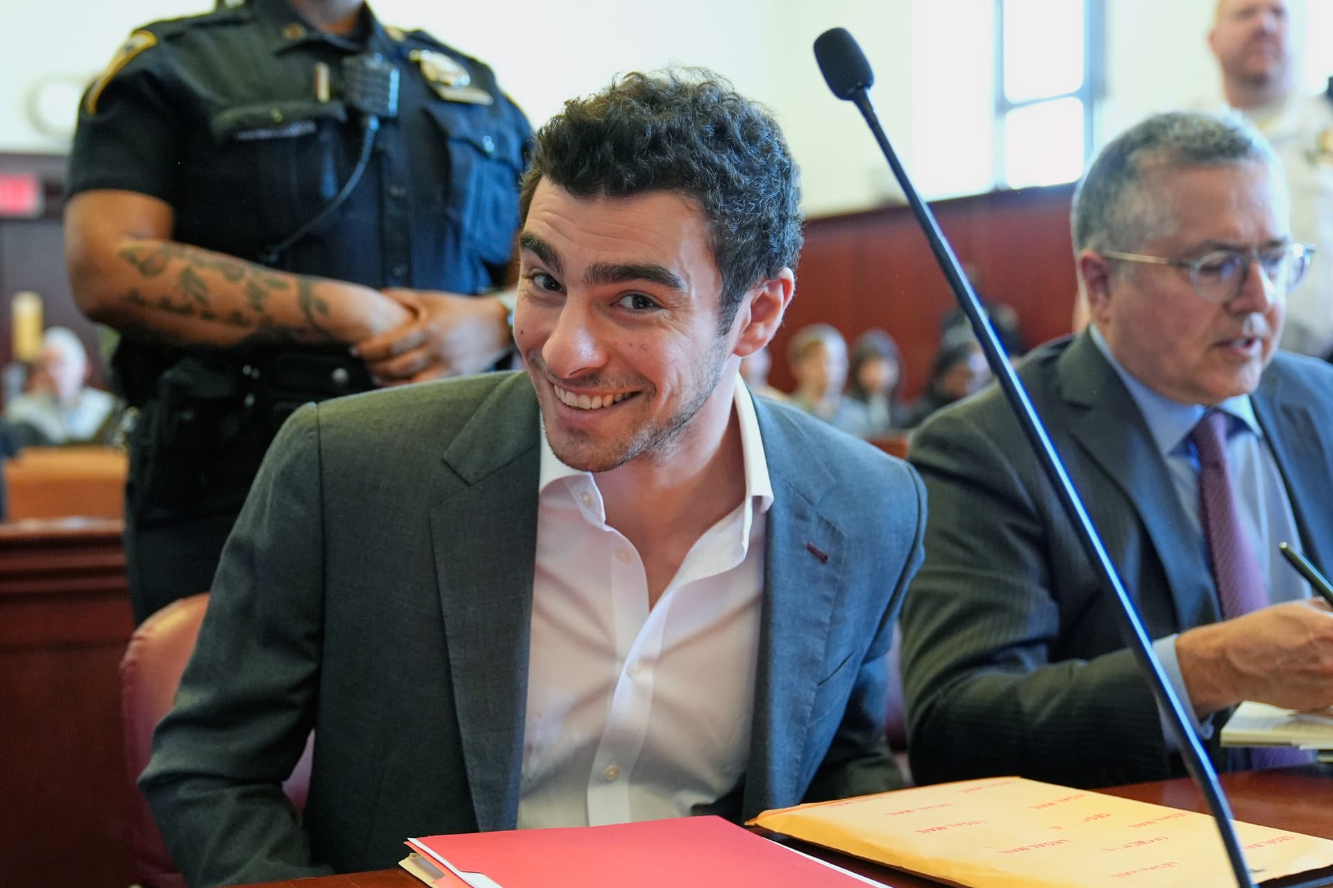 Seth Wenig-Pool/Getty Images Luigi Mangione (L) sits next to his attorney, Marc Agnifilo (RO) as he appears for a suppression of evidence hearing in the killing of UnitedHealthcare CEO Brian Thompson in Manhattan Criminal Court on December 16, 2025.