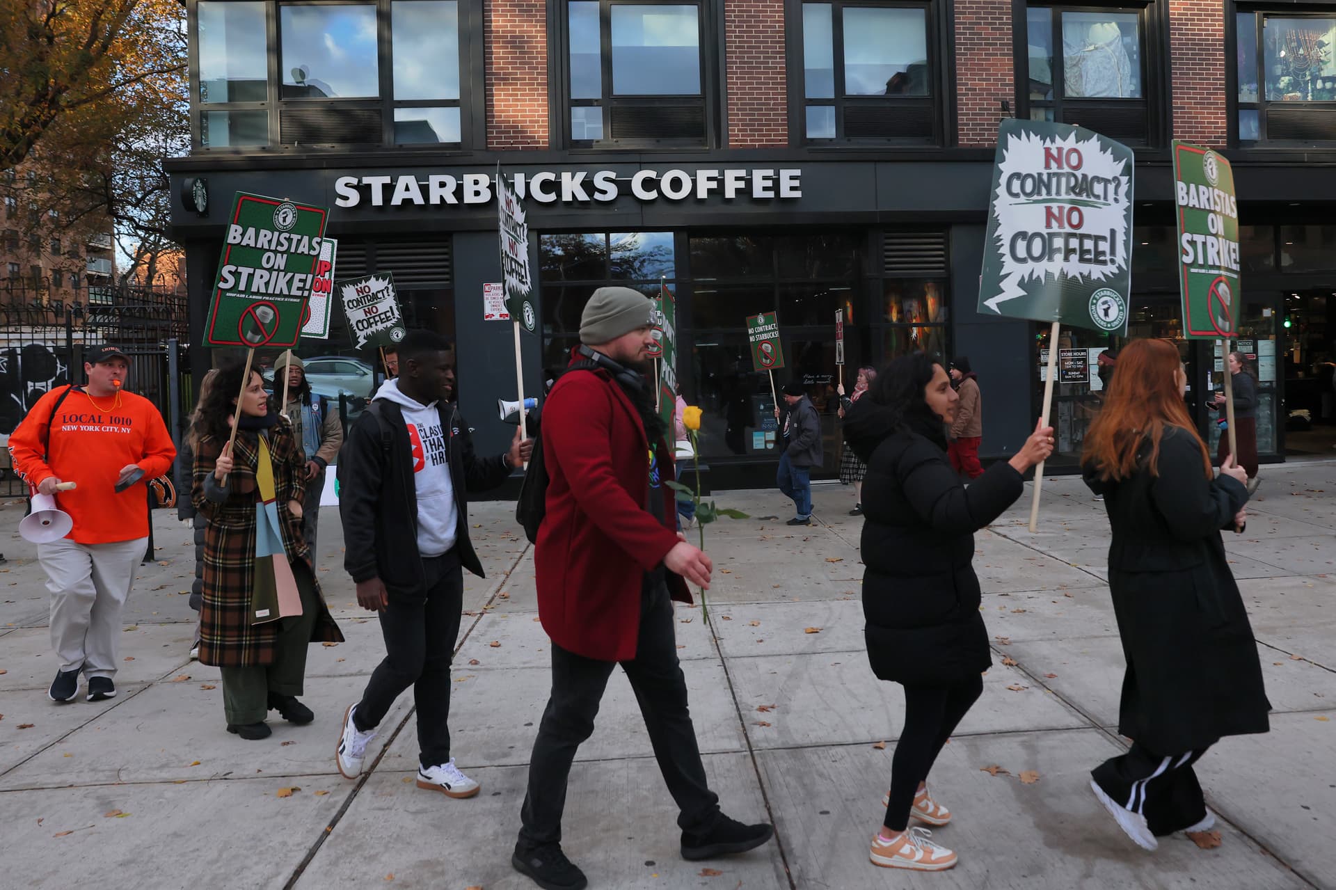 Michael M. Santiago/Getty Images Striking Starbucks employees on November 13, 2025 at the Clinton Hill neighborhood of Brooklyn.