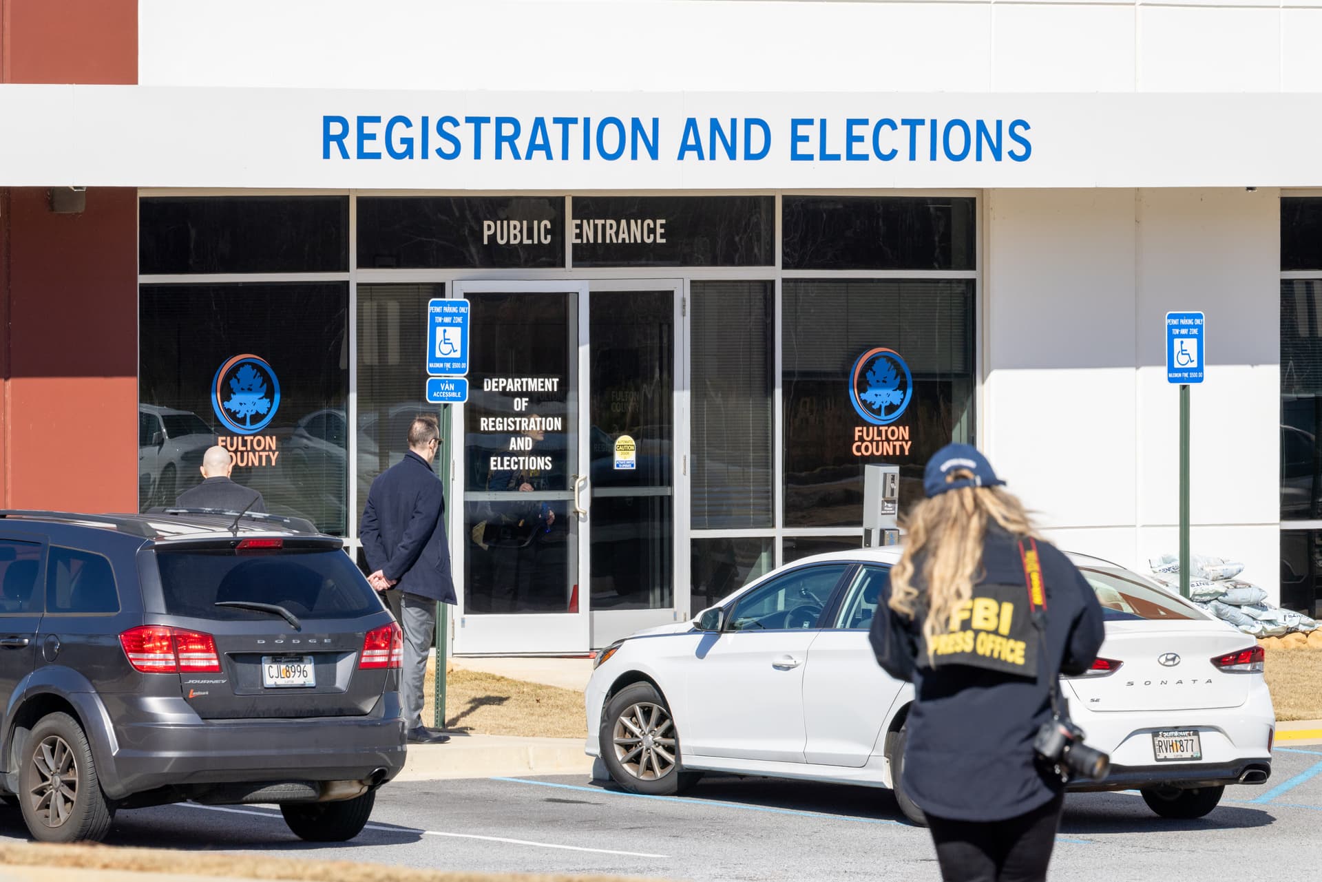 Arvin Temka/Atlanta Journal-Constitution via AP An FBI press office person approaches the Fulton County Election Hub and Operation Center on January 28, 2026, at Union City, Ga.