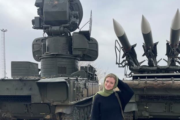 Calla Walsh via X Calla Walsh poses in front of what she describes as Iranian missiles during her visit to Iran on February 13, 2026.
