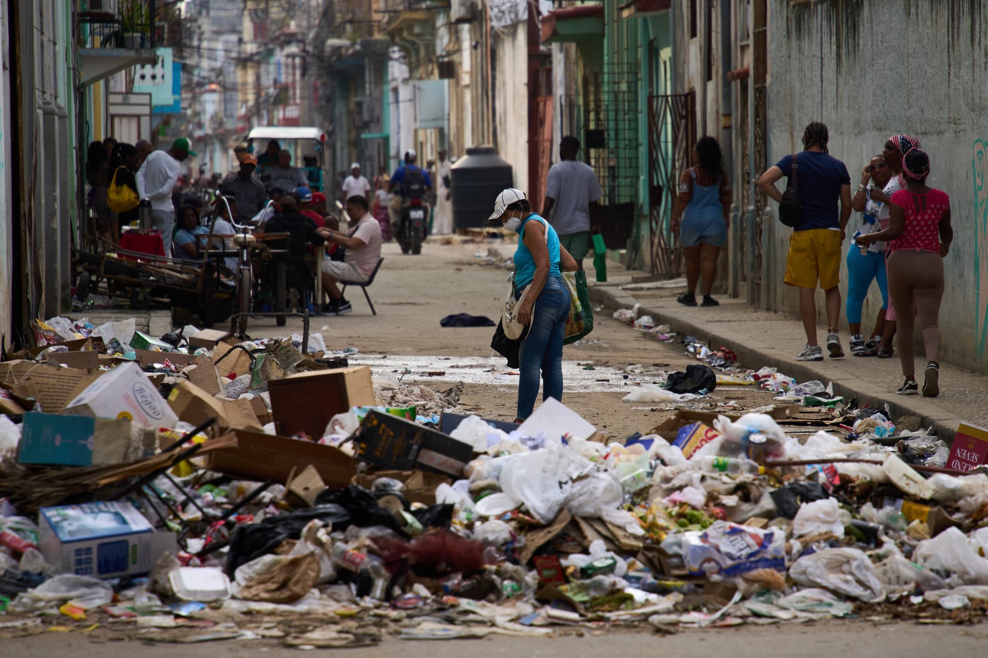 AP/Ramon Espinosa Pedestrians walk past trash at Havana, February 17, 2026.
