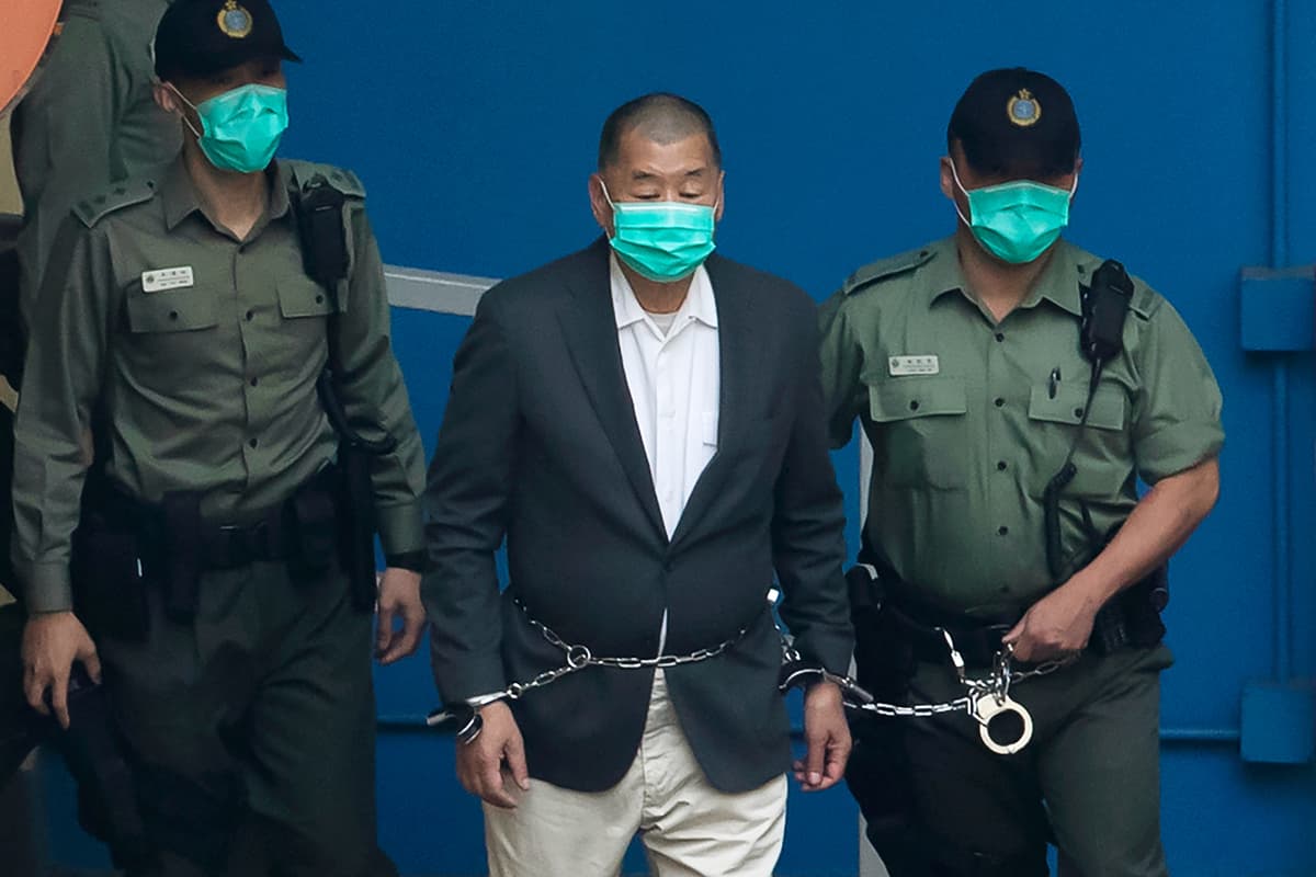 AP/Kin Cheung Hong Kong pro-democracy activist Jimmy Lai is escorted by officers to get on a prison van, December 12, 2020.