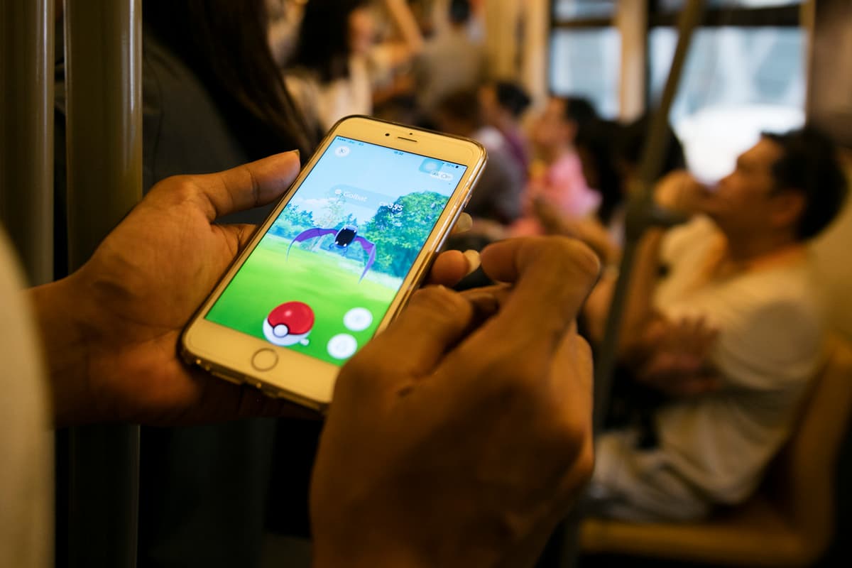 Paula Bronstein/ Getty Images A man plays Pokemon on a subway.