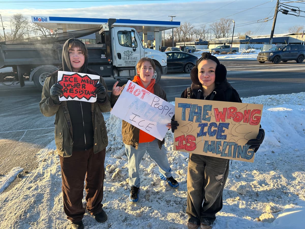 AP/Corey R. Williams From left, Asher O'Donnel, Ryan Maddox and Amari Perez-Wayner hold signs as several dozen Groves High School students walk out of morning class on January 30, 2026 in Birmingham, Michigan.