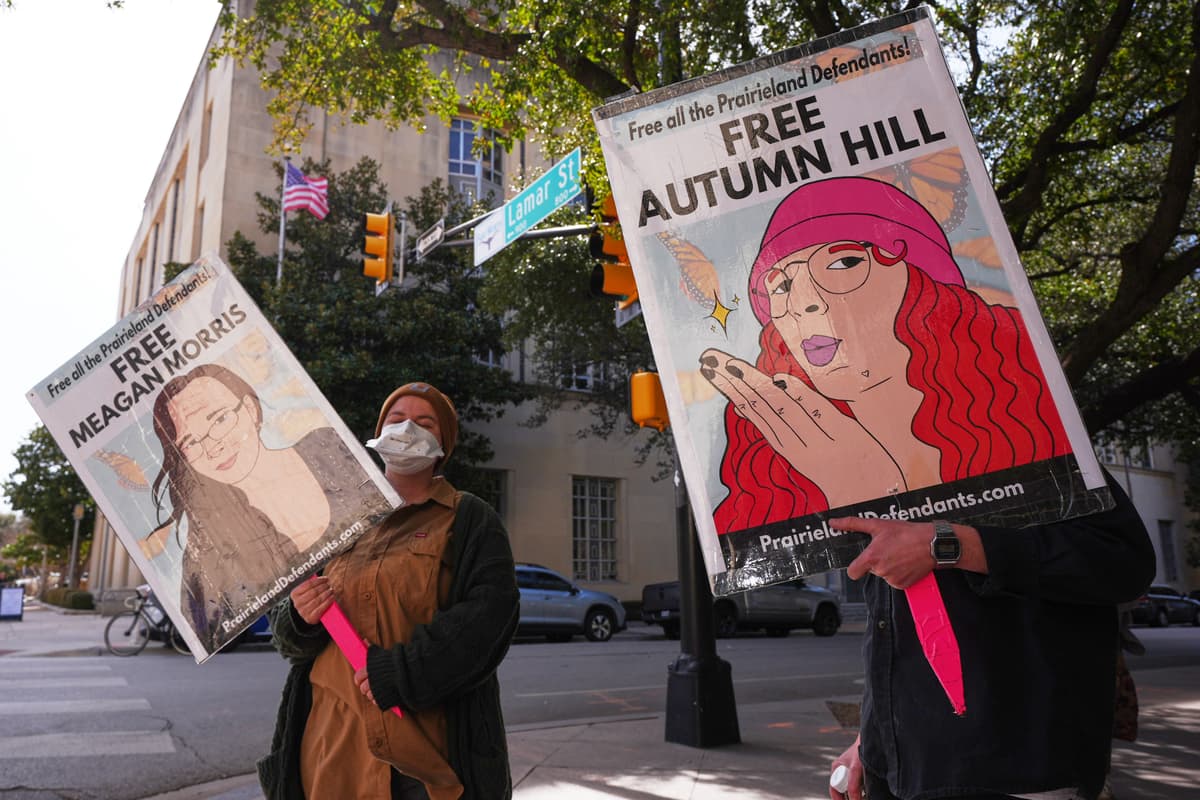 LM Otero/AP People hold signs outside a federal courthouse at Fort Worth, Texas, on February 23, 2026, during a trial for nine people connected to a 2025 shooting outside an ICE detention facility.