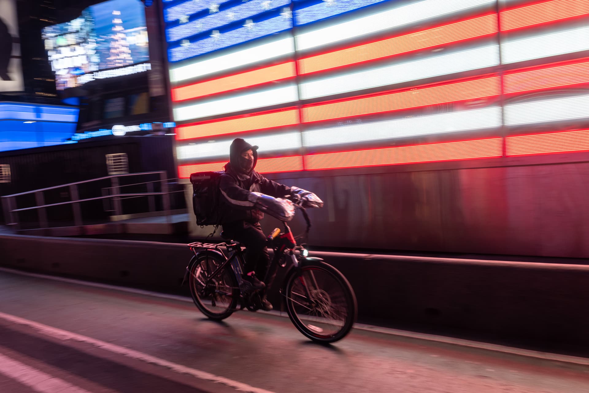 Spencer Platt/Getty Images A food delivery worker uses an electric bicycle at New York City's Times Square.