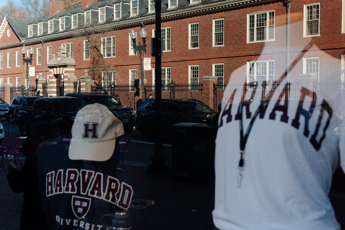 Sophie Park/Getty Images Harvard University is reflected in the window of a merchandise store across the street from the campus at Cambridge, Massachusetts, on April 17, 2025.